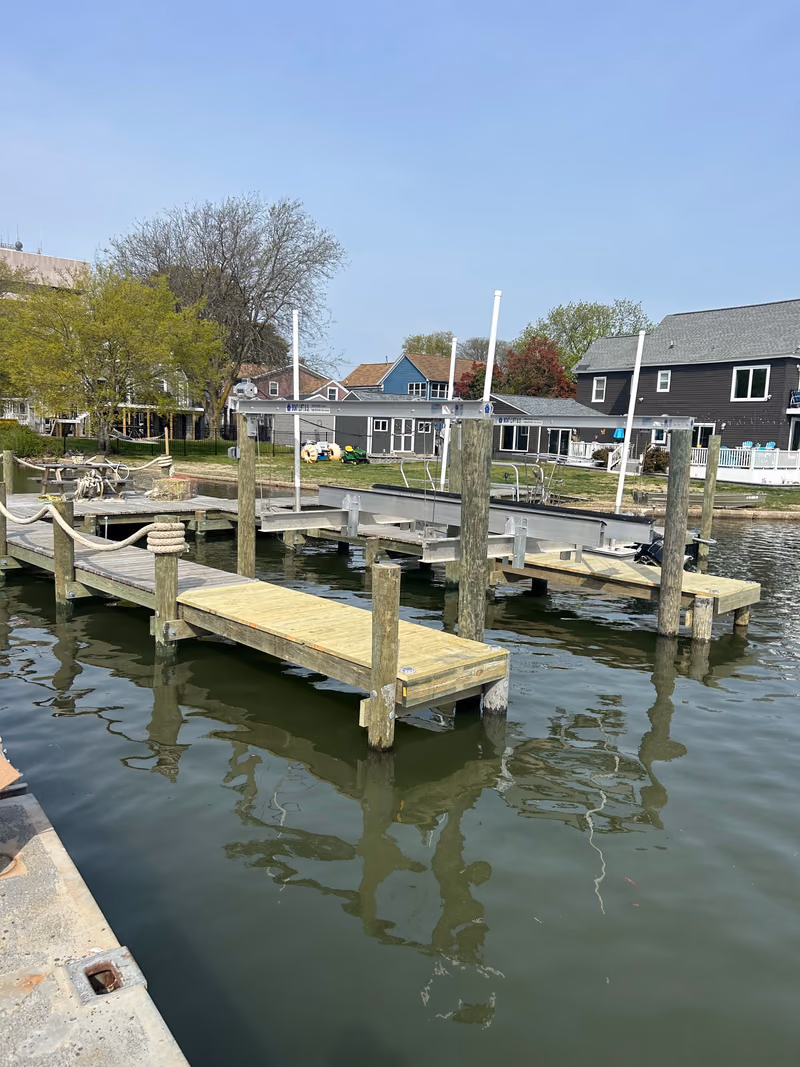 A newly built residential dock among older neighbouring docks on a waterfront street.